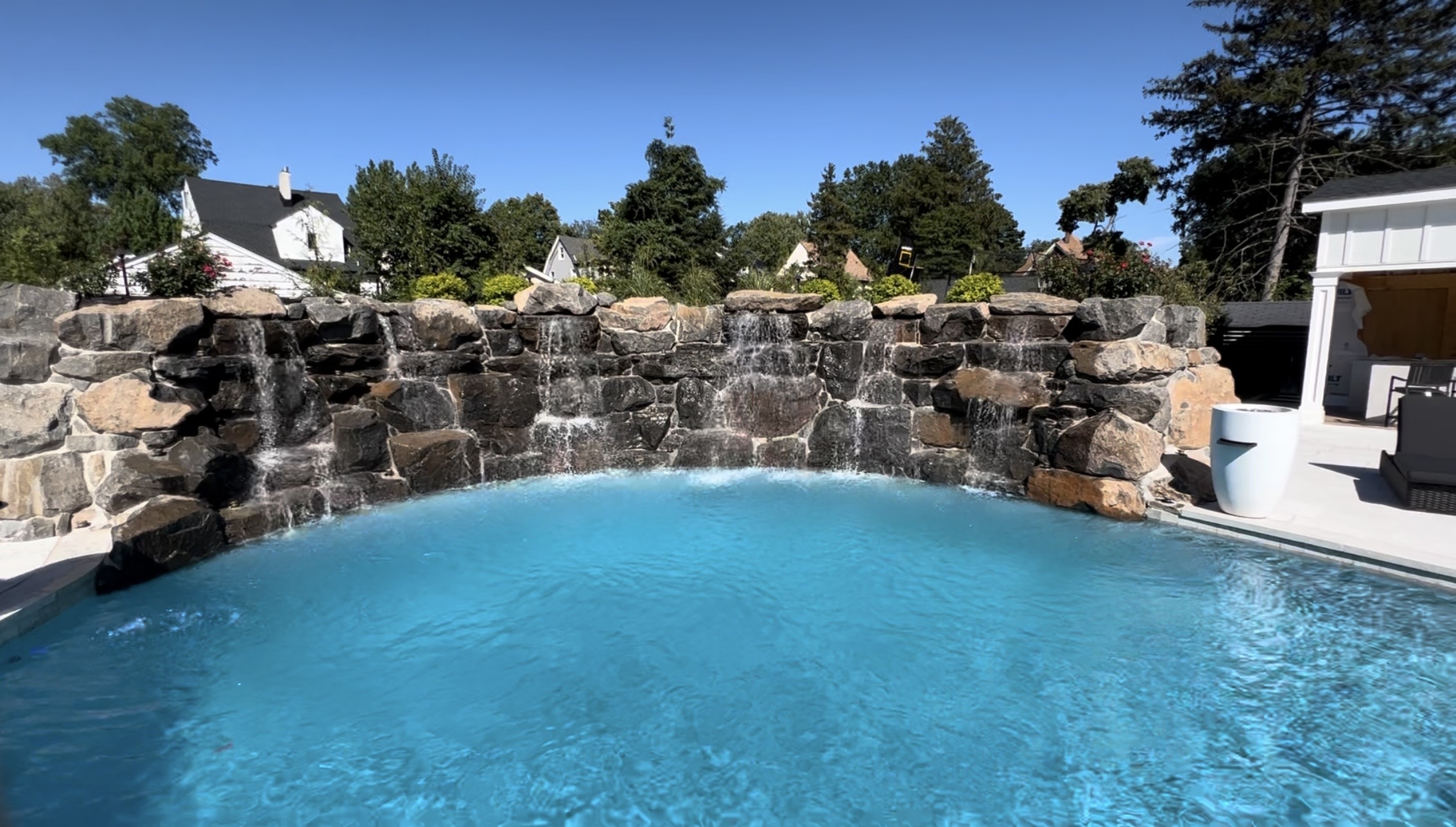 Luxurious stone patio and landscaping by Rock-N-Gardens