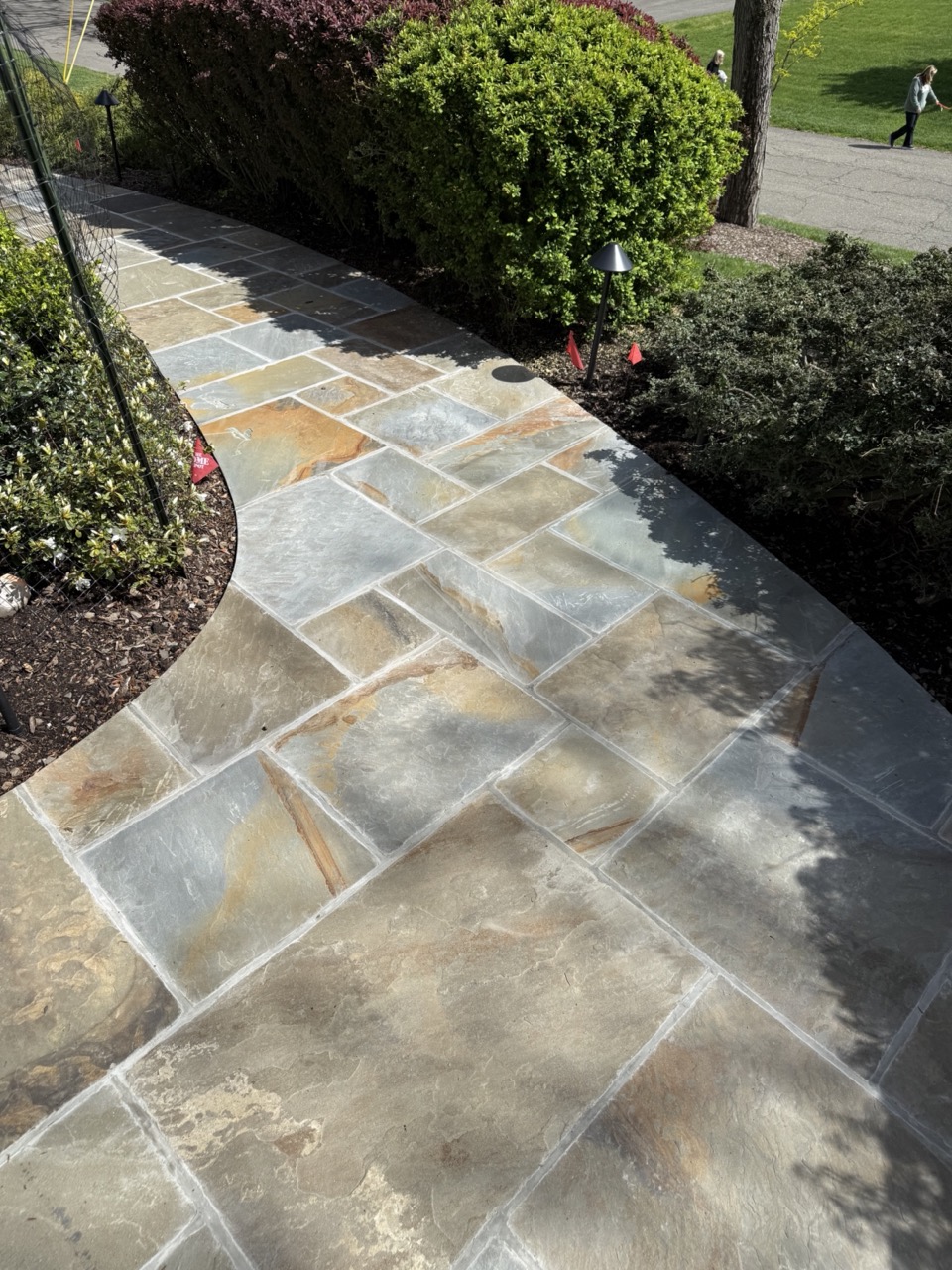 Bluestone garden path with low-voltage landscape lighting and perennial borders