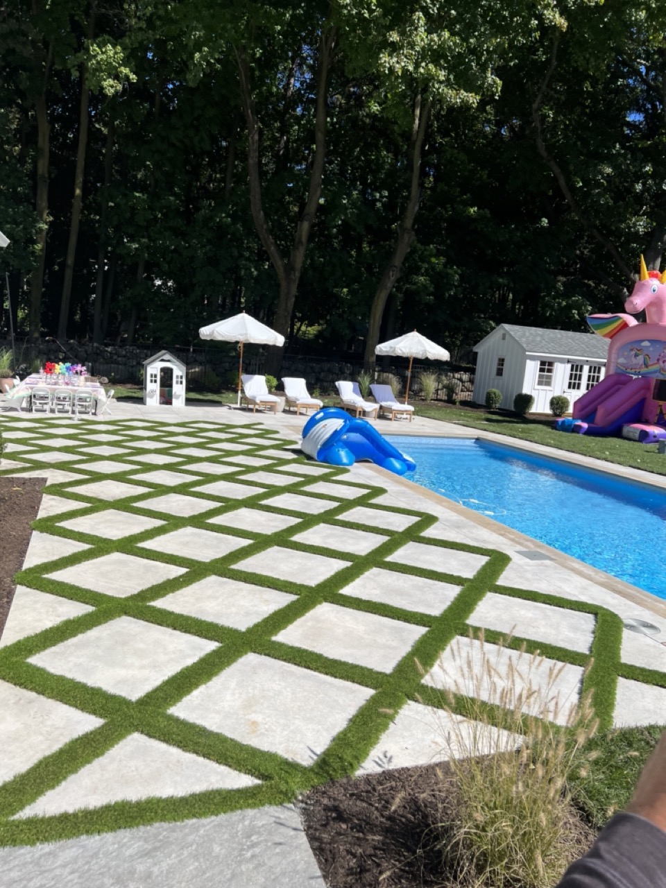 Large-format stone slab and artificial turf grid pool surround with pool house and lounge chairs — Wyckoff